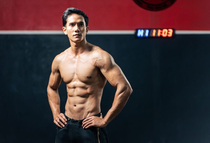 Man with gracilis muscle standing arms akimbo