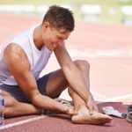 Man feeling pains in legs after workout