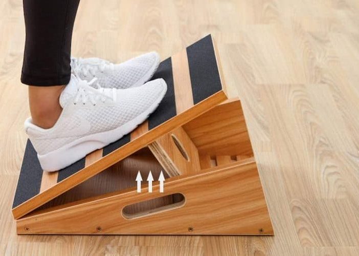 Slant board exercise - woman's feet on a slant board