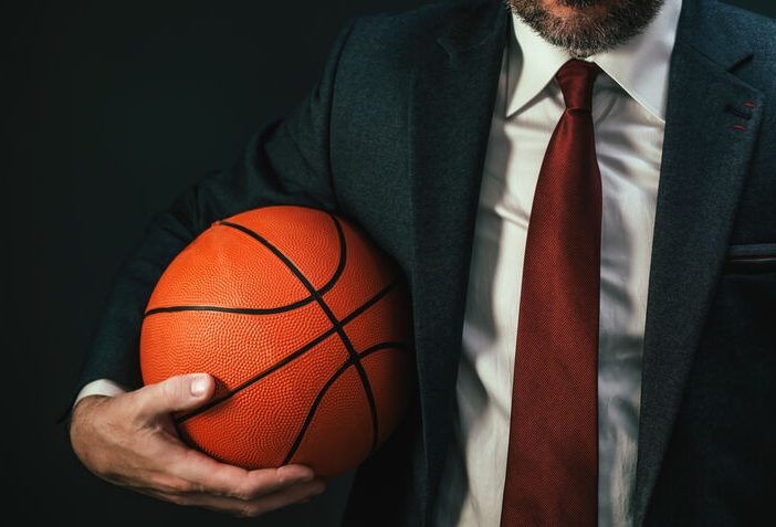 NBA agent holding a basketball in one arm