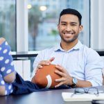 careers in sport - man sitting on chair holding baseball