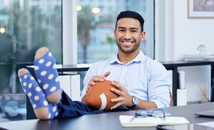 careers in sport - man sitting on chair holding baseball