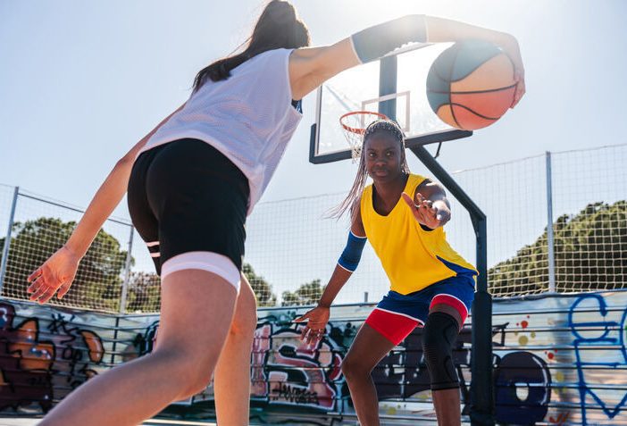 Female dribbling in basketbal game