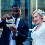 athletic trainer checking out his 100 dollar bill