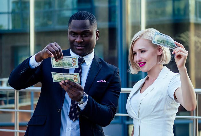 athletic trainer checking out his 100 dollar bill