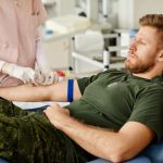 Man in hospital getting blood drawn