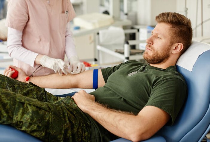 Man in hospital getting blood drawn