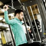 man engaging in cable pullover exercise