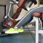 Female legs on machine during cable leg exercises