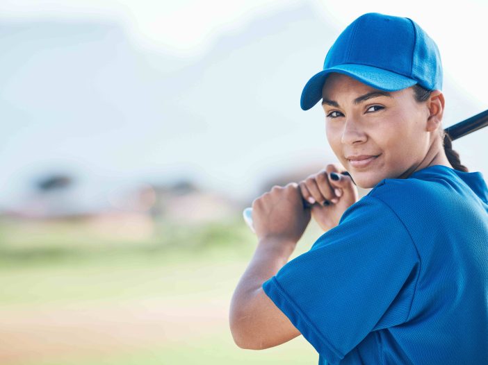Woman swinging softball bat