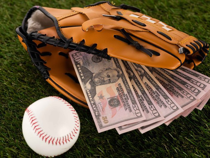 softball and wallet of money