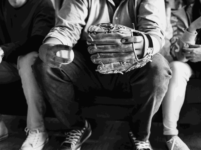 Man holding a softball in monochrome picture
