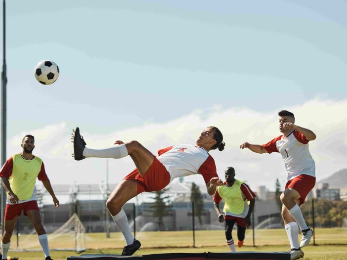 Soccer player using the scissors kick