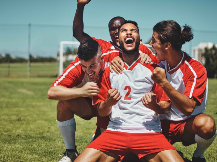 Soccer team jubilating after a goal